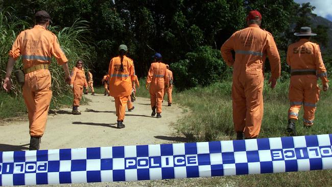 NO ANSWERS: SES workers scour a track beside Behana Creek, south of Gordonvale in May 2000 following the disapperance of Cairns teen Angela Mealing a month earlier. PICTURE: ANNA ROGERS