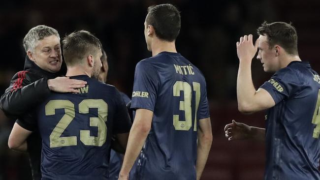 Manchester United head coach Ole Gunnar Solskjaer embraces his players after they defeated Arsenal in the FA Cup. Picture: AP