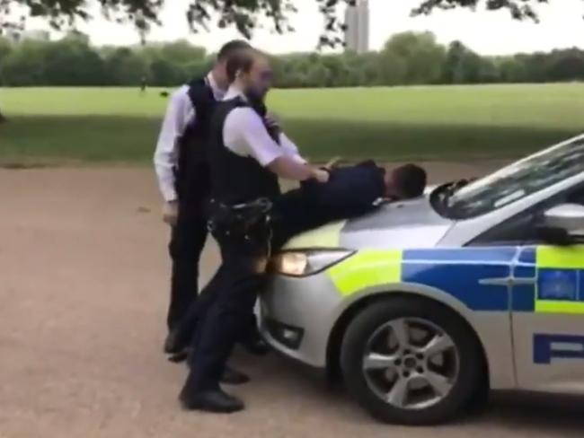 The man is restrained by British police. Picture: Twitter