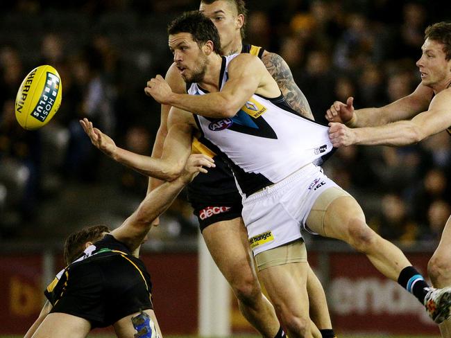 Power captain Travis Boak gets a handpass away under pressure against Richmond. Picture: Colleen Petch