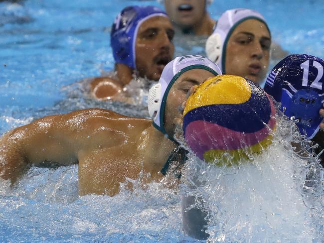 Australia's Joel Kayes, left, and Greece's Angelos Vlachopoulos, right, battles for the ball during their men's water polo preliminary round match at the 2016 Summer Olympics in Rio de Janeiro, Brazil, Sunday, Aug. 14, 2016. (AP Photo/Eduardo Verdugo)