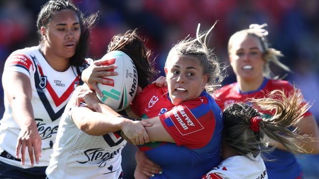 NEWCASTLE, AUSTRALIA - SEPTEMBER 09: Caitlan Johnston of the Knights is tackled during the round eight NRLW match between Newcastle Knights and Sydney Roosters at McDonald Jones Stadium on September 09, 2023 in Newcastle, Australia. (Photo by Jason McCawley/Getty Images)