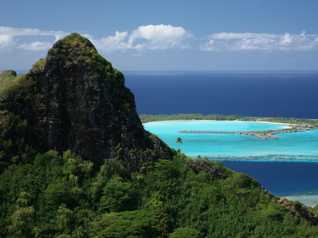 MOUNTAIN PEAKS, TAHITI, FRENCH POLYNESIA Heavenly Tahiti has the highest mountains in the South Pacific, with large rocky outlooks standing proud over sheltered, pristine waters below. The island’s jagged mountain peaks feature stunning natural scenery and clearly offer the best views in the house. Picture: Gregoire Le Bacon / South Pacific Tourism Organization