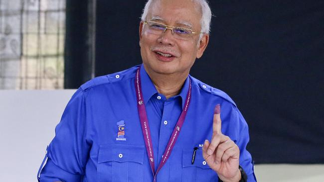 Malaysian Prime Minister Najib Razak smiles after voting. Picture: AP.