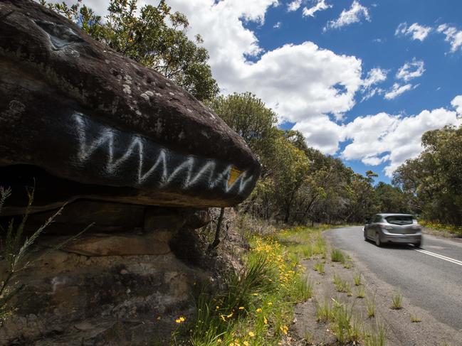 GV's of Morgan Rd, which runs between Oxford Falls and Belrose. The road has (apparently) become a bit of a goat track that is being used as a rat run by motorists trying to avoid the traffic chaos around the hospital at Frenchs Forest . The road was pictured at the large rock that is painted to look like the head of a blue-tongue lizard on 3rd December 2017. (AAP Image / Julian Andrews)