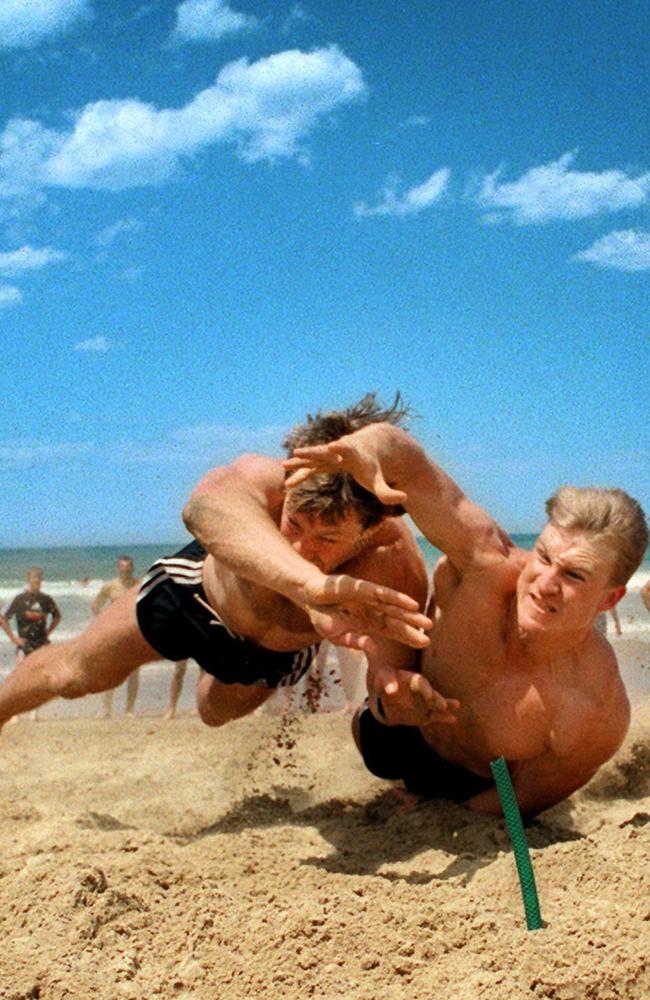 Nathan Buckley just beats Gavin Brown in a strongly contested heat of the beach flags race as Collingwood players went through their paces at a hot pre-season football training camp at Lorne in 1997.