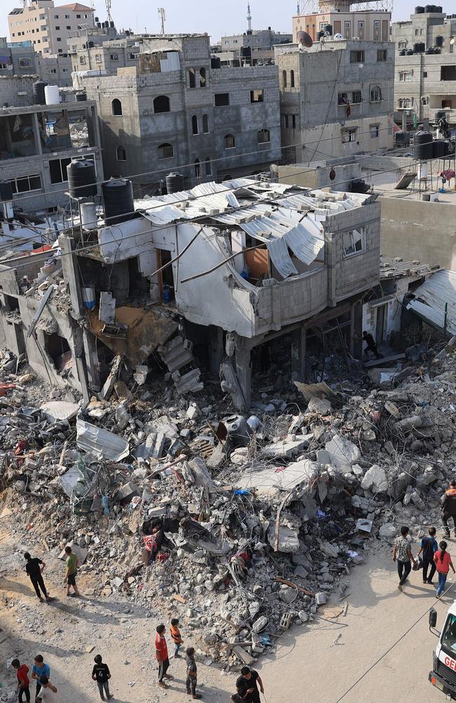 Palestinians gather around the rubble of buildings hit during Israeli air strikes on Rafah in the southern Gaza Strip. Picture: AFP