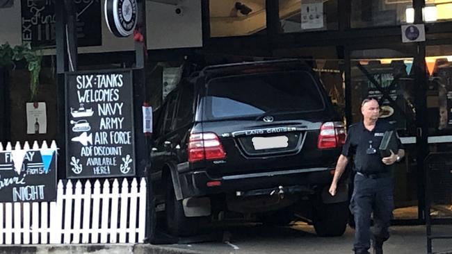 The 4WD still wedged into the entrance of the Six Tanks Brew Co. pub on Mitchell St on Sunday morning. Picture: Madura McCormack/NT News