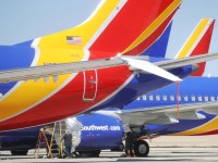 VICTORVILLE, CA - MARCH 27: Workers stand beneath Southwest Airlines Boeing 737 MAX aircraft parked at Southern California Logistics Airport on March 27, 2019 in Victorville, California. Southwest Airlines is waiting out a global grounding of MAX 8 and MAX 9 aircraft at the airport.   Mario Tama/Getty Images/AFP == FOR NEWSPAPERS, INTERNET, TELCOS & TELEVISION USE ONLY ==