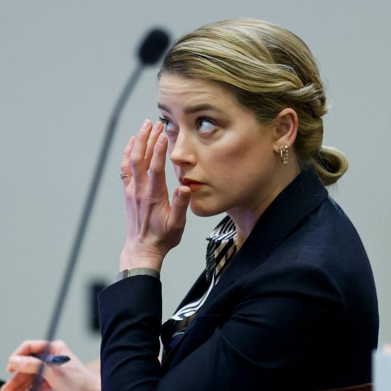 Amber Heard reacts as a prerecorded deposition testimony of Christian Carino is played. (Photo by JONATHAN ERNST / POOL / AFP)