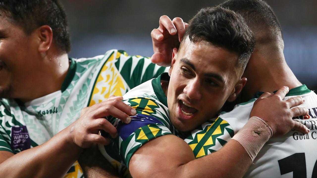 Kayal Iro of the Cook Islands celebrates scoring a try.