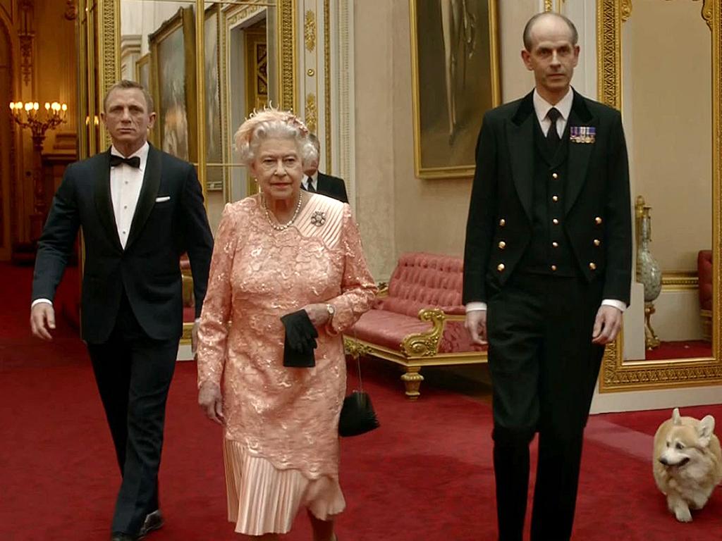 James Bond escorting Britain's Queen Elizabeth II and her corgis through the corridors of Buckingham Palace. Picture: AFP