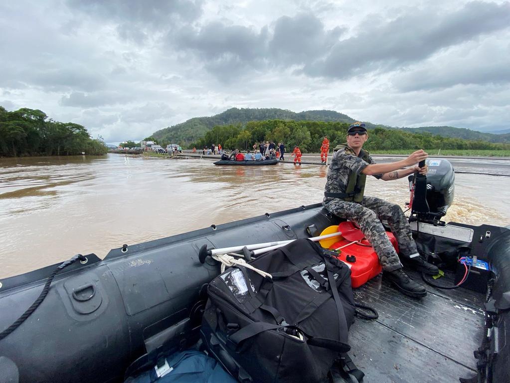 Royal Australian Navy personnel work with civilian emergency services to evacuate members of the public from Holloways Beach. Picture: Supplied