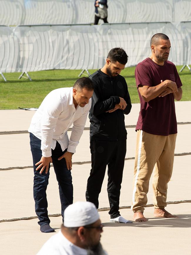 Australian boxer Anthony Mundine (right) joins Muslims for the call to pray at Hagley Park. Picture: AAP Image/SNPA, Martin Hunter