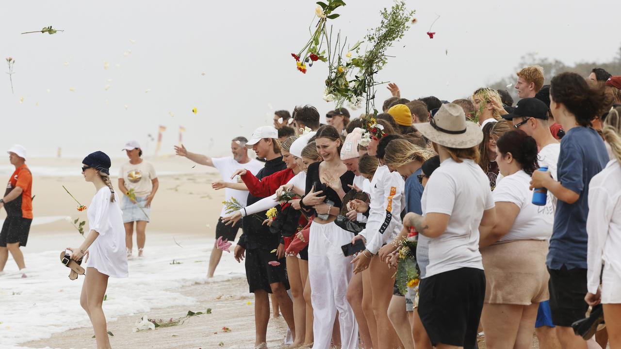 Family and friends of 16-year-old alleged stabbing victim Balin Stewart gather to pay tribute on his home beach at Buddina. Picture: Lachie Millard