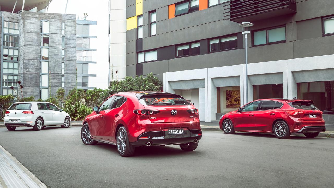 The Volkswagen Golf (left), Mazda3 (middle) and Ford Focus are three of the most accomplished small cars on the market. Photo: Thomas Wielecki.