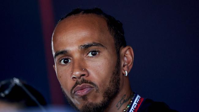 Mercedes' British driver Lewis Hamilton looks on in the paddock at the Bahrain International Circuit in Sakhir ahead of the Bahrain Formula One Grand Prix on March 2, 2023. (Photo by Giuseppe CACACE / AFP)