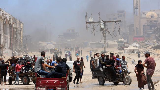Palestinians transport their belongings as they flee the northern Gaza Strip toward the south, along the coastal al-Rashid road on Saturday. Picture: Omar Al-Qattaa / AFP