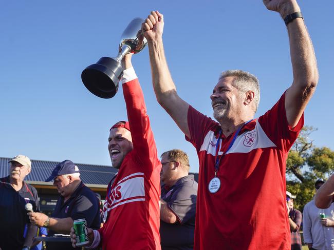 Bloods captain Paul Hill and coach Darren “Darts’’ Arter raise the cup. Picture: Valeriu Campan