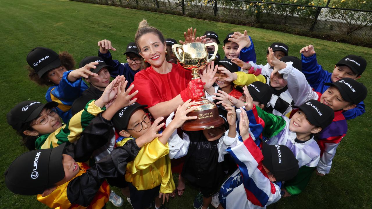 Melbourne Cup jockey Michelle Payne holds up the Lexus Melbourne Cup from students from St Margaret’s Primary School, Maribyrnong. Picture: David Caird