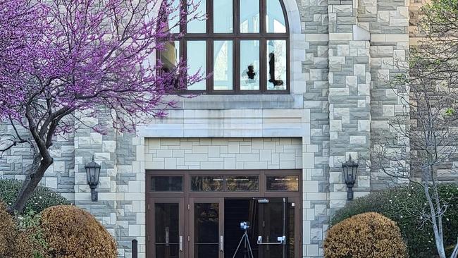 This image shows the second-storey broken windows the shooter fired from on arriving police vehicles at the Covenant School. Picture: Handout/Metro Nashville Police Department/AFP