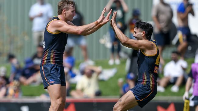 Crows captain Jordan Dawson (left) celebrates a goal with teammate Izak Rankine in the AFL Community Series match against West Coast at Richmond Oval. Picture: Mark Brake/Getty Images