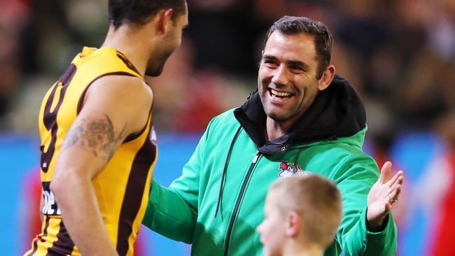 Melbourne Storm skipper Cameron Smith chats with Hawthorn's Shaun Burgoyne. Picture: Michael Klein