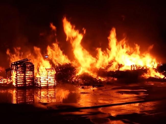 Firefighters have extinguished a large fire at a pallet yard in Sydney's southwest. Picture: Fire and Rescue NSW