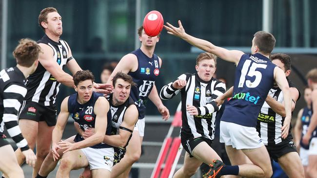 Tasmanian State League. Jared Dakin (Launceston) is held by Glenorchy’s Ben Kamaric as he offloads to Tyson Miller at KGV. Picture: NIKKI DAVIS-JONES