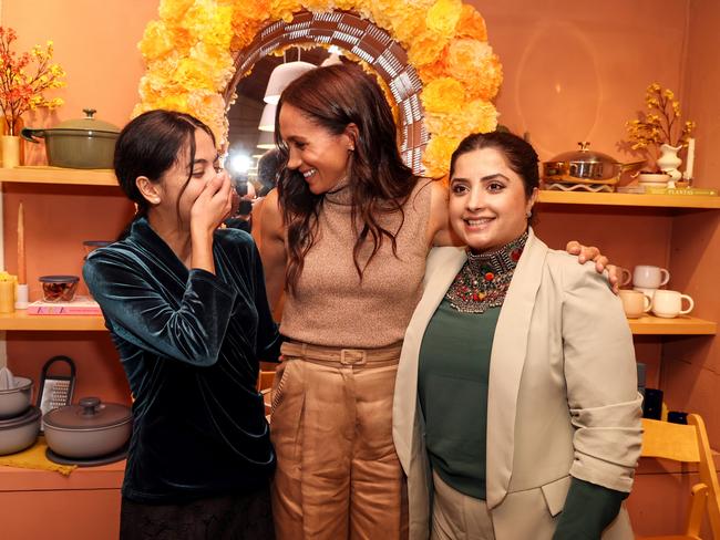 The Duchess of Sussex warmly embraces the young girl and another guest. Picture: The Archewell Foundation via Getty Images