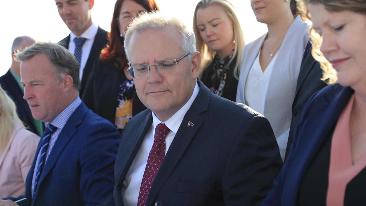 Australian Prime Minister Scott Morrison (centre), Tasmanian Premier Will Hodgman (left) and Hobart Mayor Anna Reynolds (right) sign the Hobart City Deal at Hobart Airport in Tasmania, Sunday, February 24, 2019. Hobart's long-awaited City Deal will be revealed as a 10-year, $1.43 billion commitment spread across tourism, science, traffic solutions and affordable housing. (AAP Image/Rob Blakers) NO ARCHIVING