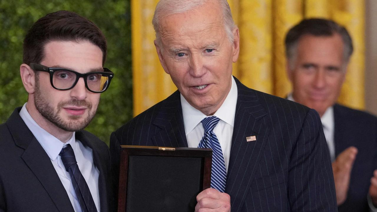 Alex Soros accepting the medal for his father, George. That’s Mitt Romney in the background, who was there to accept the posthumous medal for his own father. Picture: Chris Kleponis/AFP