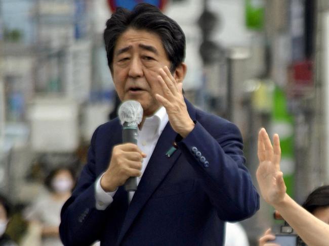 Japanese former Shinzo Abe speaks for his party member candidate of the House of Councillors Election near Yamato Saidaiji Station in Nara Prefecture on July 8, 2022, just seconds before he is shot.  Â  67-year-old Abe has reportedly been shot in the chest and he has been in a state of cardio-respiratory arrest. ( The Yomiuri Shimbun ) (Photo by Kazuhiko Hirano / Yomiuri / The Yomiuri Shimbun via AFP)