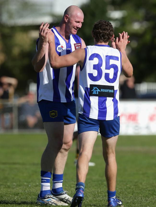 Former AFL player Barry Hall celebrates a goal with Matt Whitty while playing for Broadford in 2013.