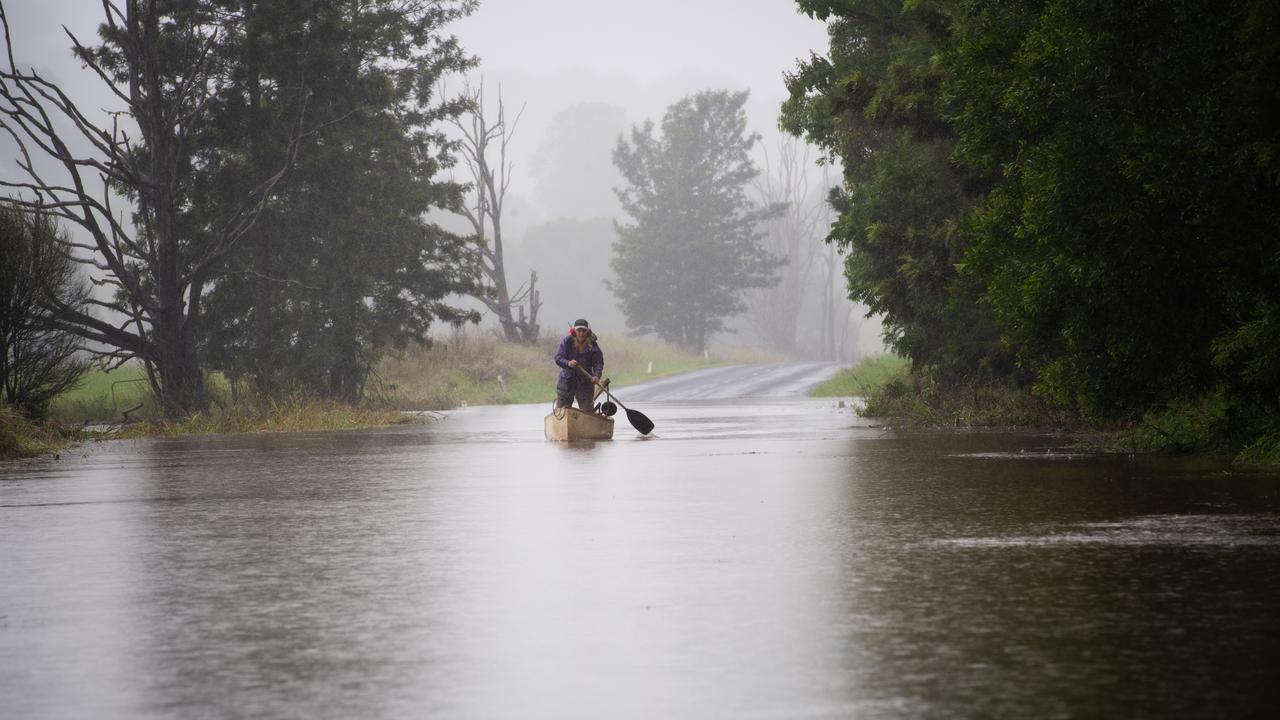 A man paddles to safety during a major flooding event. Photo: NewsWire/ Elise Derwin