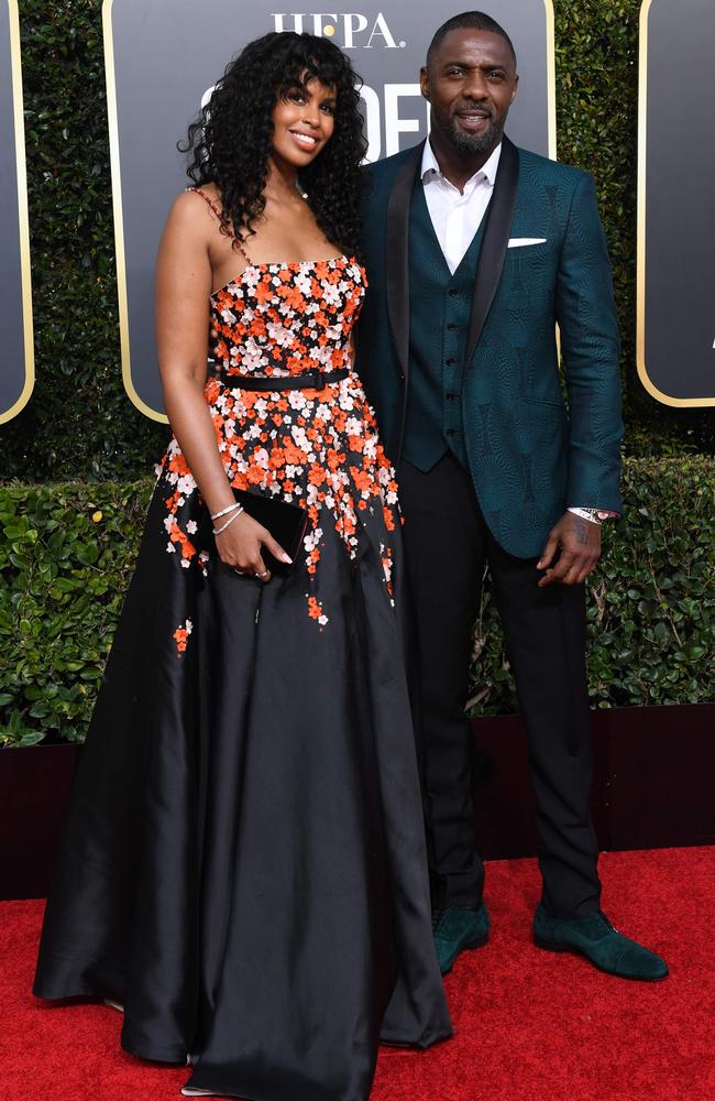 Actor Idris Elba - pictured with his fiancee Sabrina Dhowre - appeared to also be wearing a Time’s Up band. Photo: Valerie Macon/AFP