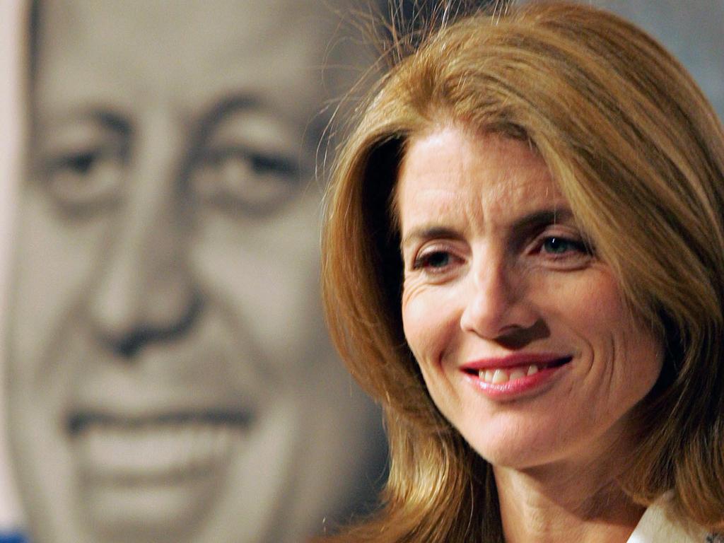 Caroline Kennedy, sits in front of an image of her late father President John F. Kennedy at the John F. Kennedy Presidential Library and Museum in Boston. Caroline Kennedy has told New York Govenor David Paterson she wants to be the state's next U.S. Senator, becoming the highest-profile name to actively lobby for the seat being vacated by Hillary Rodham Clinton.