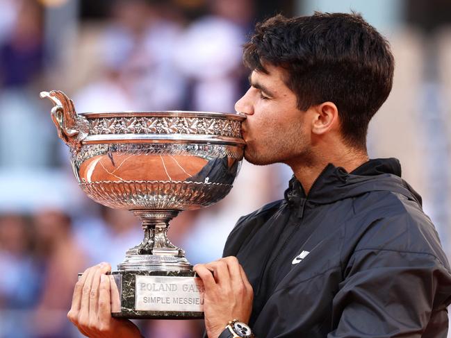 Spain's Carlos Alcaraz kisses the trophy after winning against Germany's Alexander Zverev in the men's singles final match on Court Philippe-Chatrier on day fifteen of the French Open tennis tournament at the Roland Garros Complex in Paris on June 9, 2024. (Photo by EMMANUEL DUNAND / AFP)