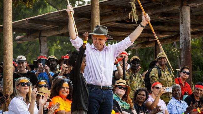 Prime Minister Anthony Albanese receives traditional gifts from a young Yolngu boy during Garma. Picture: Tamati Smith/Getty Images