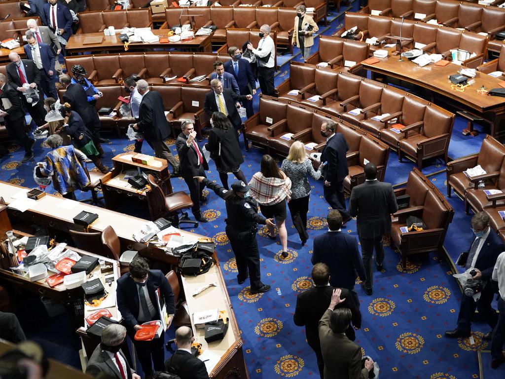 Members of Congress evacuate the House Chamber as pro-Trump protesters attempt to enter during a joint session of Congress. Picture: Getty Images