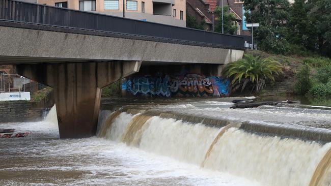 Water overflowing at the weir in Parramatta. Picture: David Swift