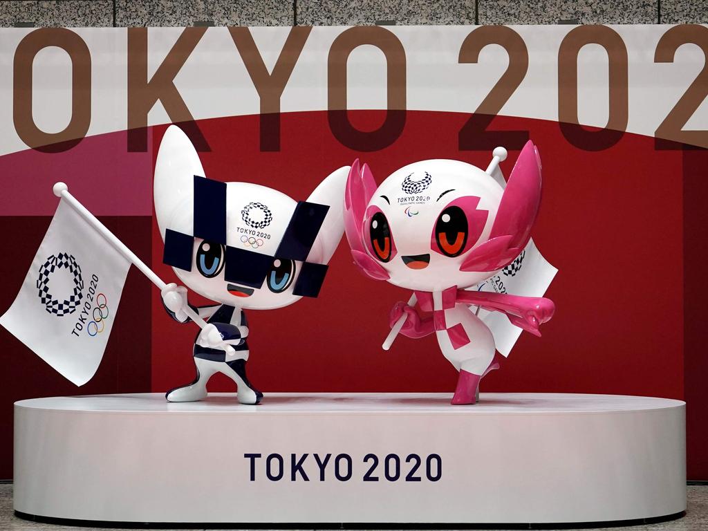 The unveiled statues of Miraitowa (L) and Someity, the officials mascots for the Tokyo 2020/2021 Olympics and Paralympics Games, are seen to mark 100 days before the start of the Olympic Games Tokyo 2020 at the Tokyo Metropolitan Government building in Tokyo on April 14, 2021. (Photo by Eugene Hoshiko / POOL / AFP)
