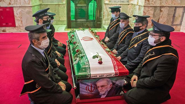 Members of Iranian forces pray around the coffin of slain nuclear scientist Mohsen Fakhrizadeh during the burial ceremony on November 30, 2020. Hamed Malekpour/Tasnim News/AFP