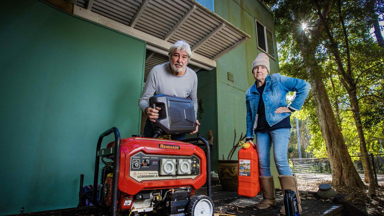 Couran Cove residents Sharon Campione and her partner Mark filling up their generators, back when services were first cut to the island. Many locals have since been forced to leave. Picture: Nigel Hallett