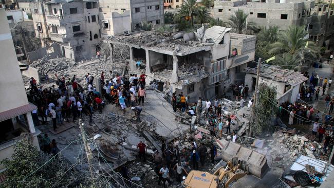 Palestinian emergency services and local citizens search for victims in buildings destroyed during Israeli air raids in the southern Gaza Strip. Picture: Getty Images