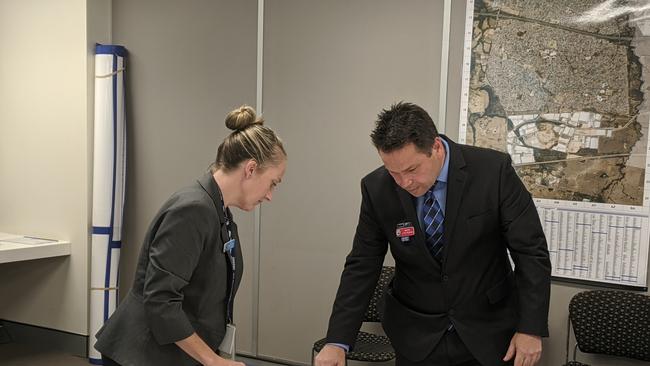 Detective Inspector Jason Pietruszka (right) and a policewoman look over maps of Castlereagh and Londonderry at St Marys police station.