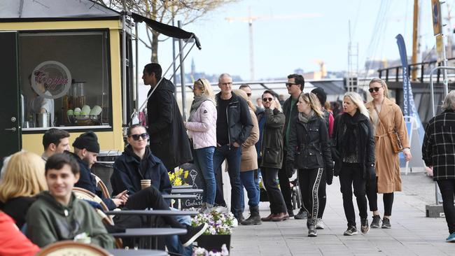 People line up to buy ice cream in Stockholm, Sweden. Picture: AFP