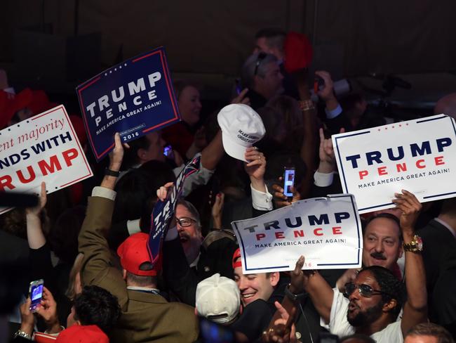 Supporters of Republican presidential nominee Donald Trump celebrate during election night at the New York Hilton Midtown in New York on November 9, 2016. / AFP PHOTO / JIM WATSON