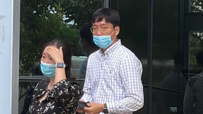 Jungjun Ahn (right) leaves Southport Courthouse with a supporter