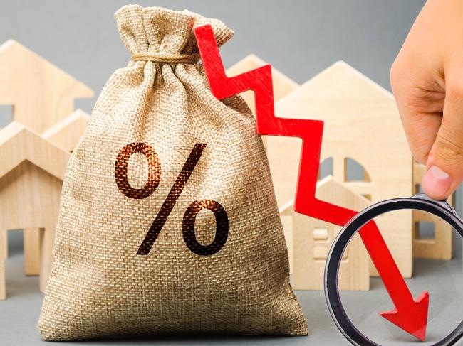 Money bag with percents, down arrow and miniature houses. The concept of low interest rates on mortgage loans or rentals. The percentage of real estate sales. Tax interest. Loan secured. Drop and fall;  Interest rates generic
